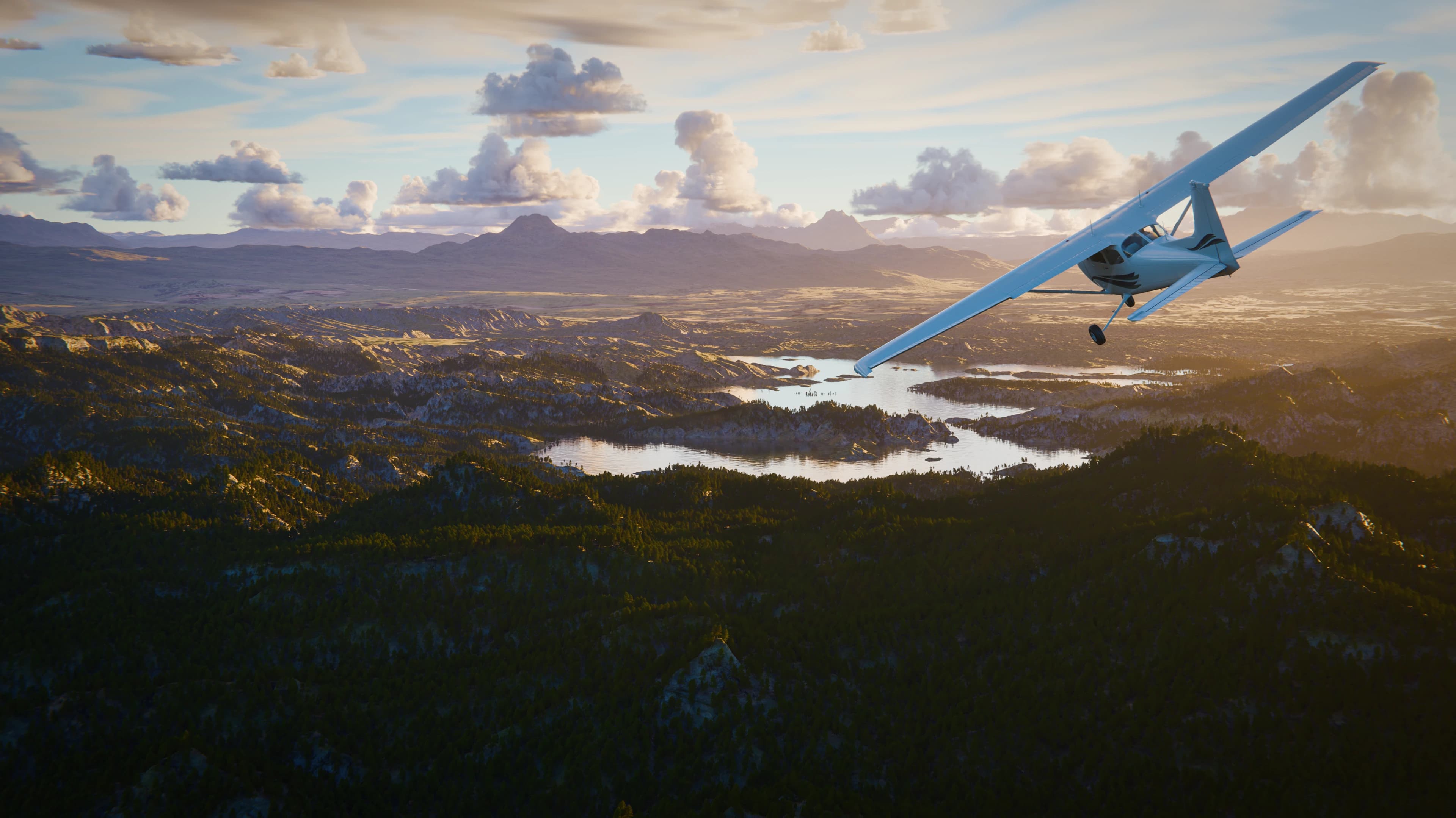 Cessna over mountain lakes at sunset