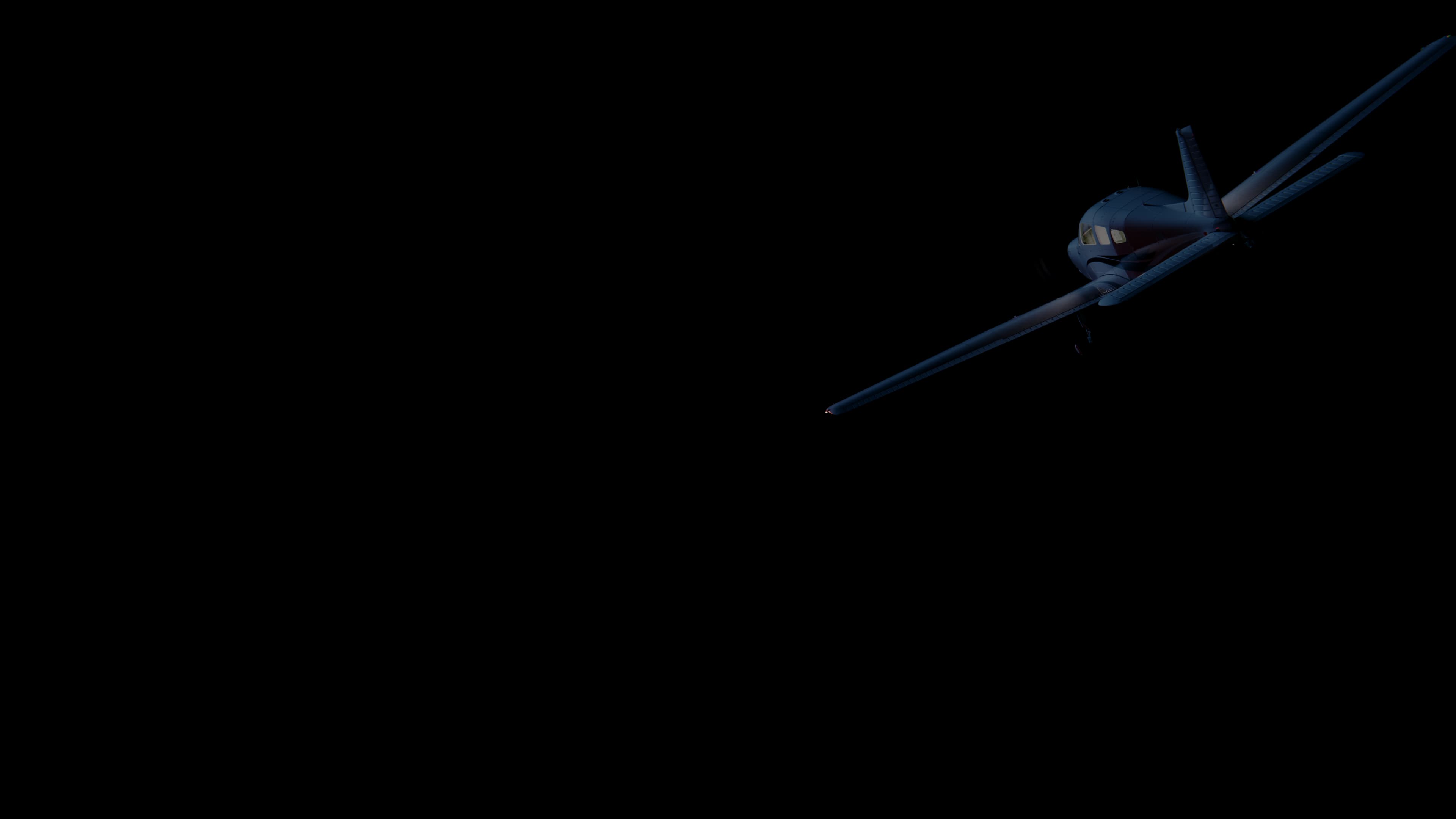 Piper Archer aircraft in flight at night